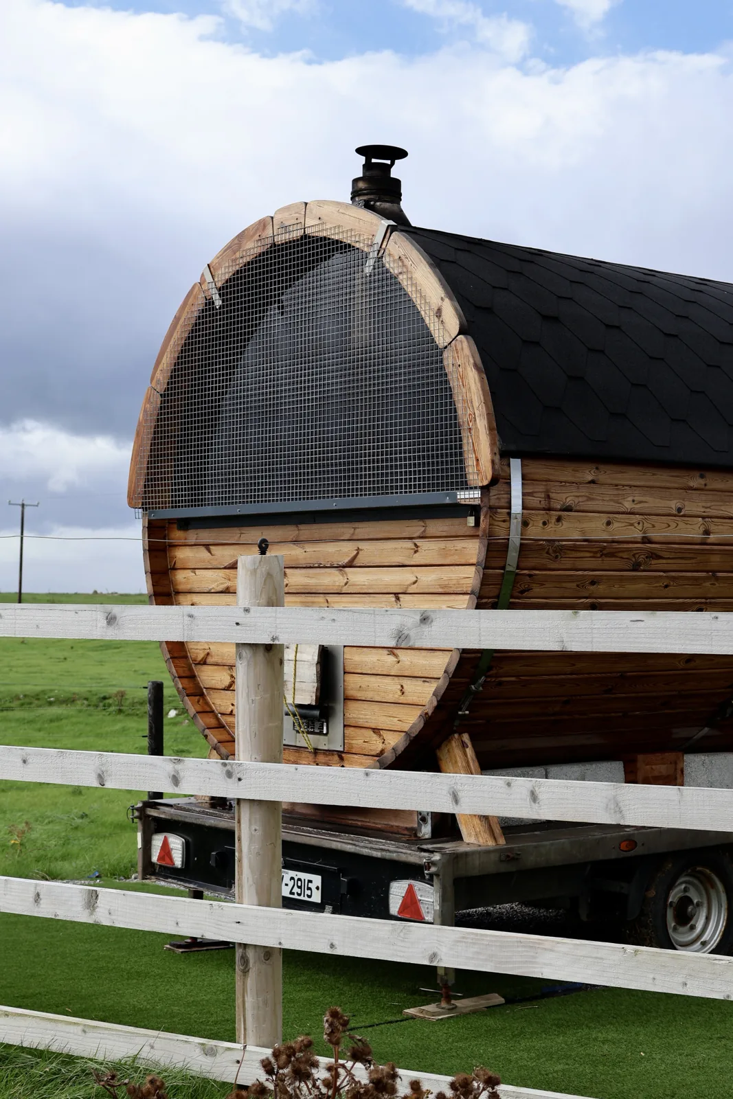 Wood fired barrel sauna at Fenit Lighthouse Sauna, overlooking Tralee Bay